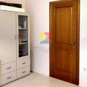 wardrobe area and wooden door