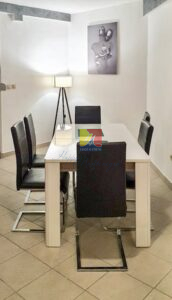 dining table with chairs around and a floor lamp