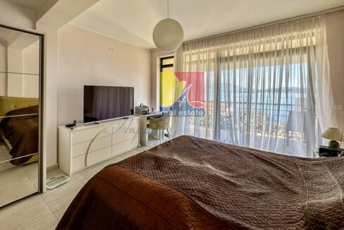 bedroom with a sea view from the balcony behind the window