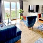 living room with with a comfy armchair facing the sea view, apartment in Baosici