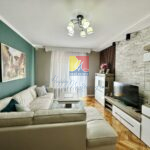 spacious living room with a big sofa, coffee table, tv, apartment by the sea in Igalo