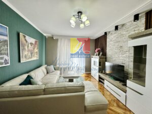 spacious living room with a big sofa, coffee table, tv, apartment by the sea in Igalo