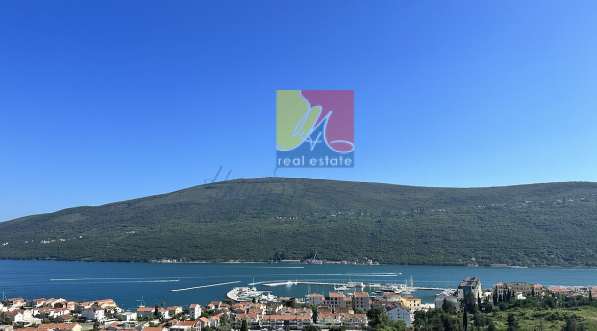 view over marina with yachts and mountains behind, luxury real estate in herceg novi